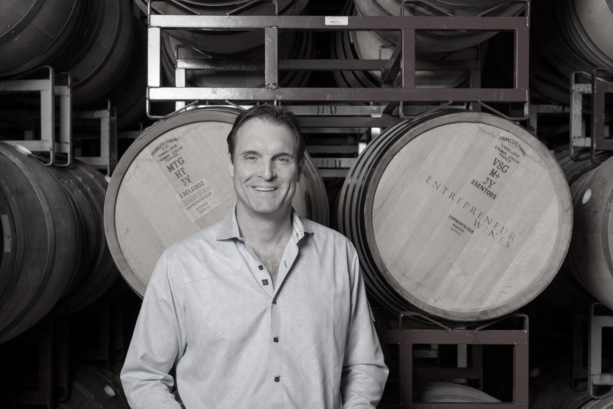 Mike Metzker, proprietor and founder, standing in the barrel hall of the Napa Valley winemaking facility.